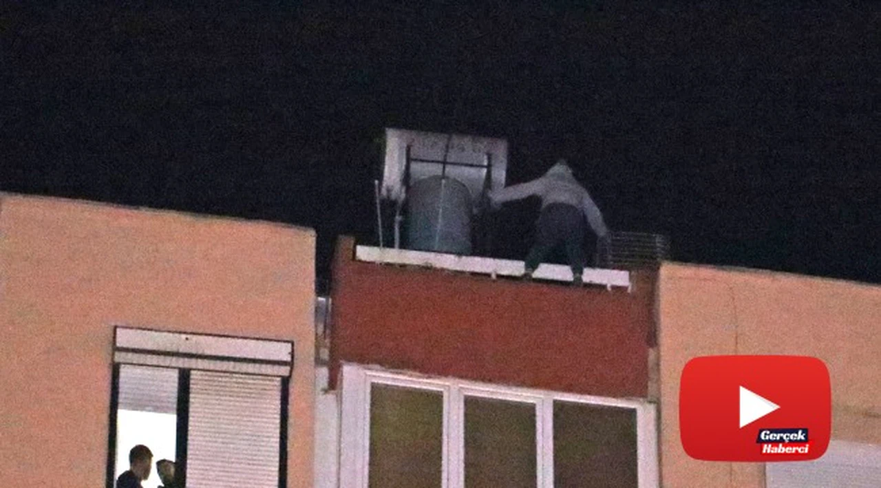 12 katlı apartmanın çatısından aşağı sarkan genç kadını film izler gibi izlediler