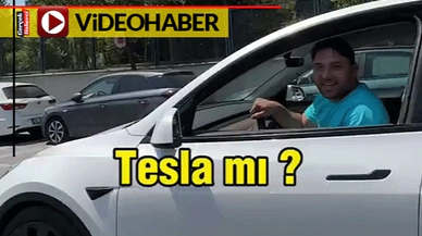 Tesla sürücüsü, "TOGG daha güzel" deyince çekim yapan kişi "O zaman sat TOGG al"
