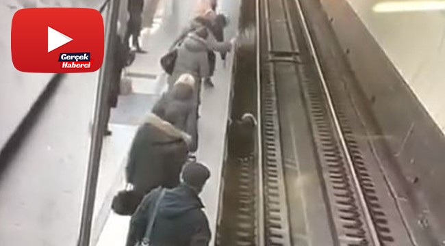 Telefonuna bakarken raylara düşen kadın ölümden kıl payı kurtuldu