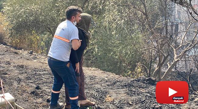 Yanan evine koşmaya çalışan kadını görevliler zor tuttu