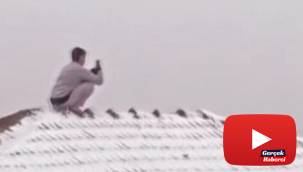 Kar fotoğrafı çekmek için canını tehlikeye atıp çatıya çıktı