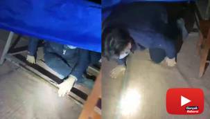 Polisi görünce masanın altında saklandı