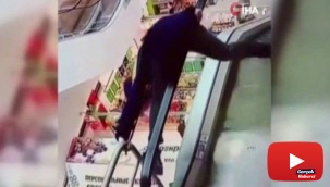 Yürüyen merdivenin bandına takıldı, aşağıya düştü