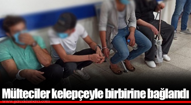 Mülteciler kelepçeyle birbirine bağlandı
