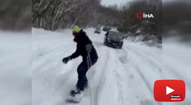 Araca bağladığı iple kayak yaptı