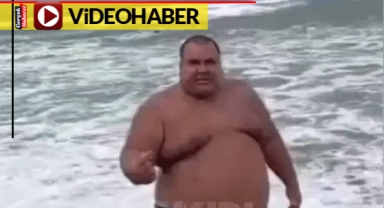 Tehlikeli yerde yüzmeye kalktı, engel olmak isteyen görevlilere hakaretler saydı